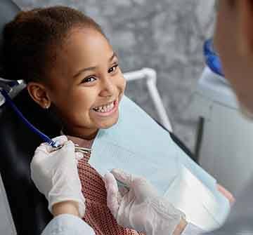 Child smiling at dentist during checkup